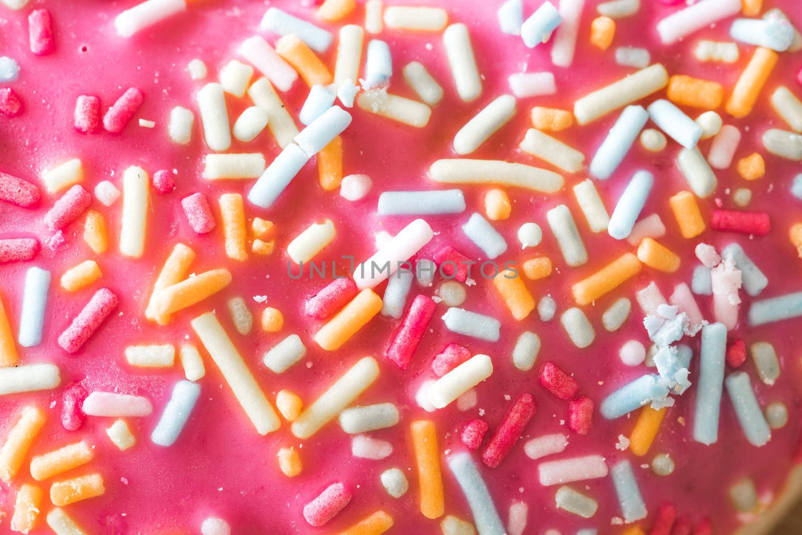 Close up of sugar sprinkled pink donut glace