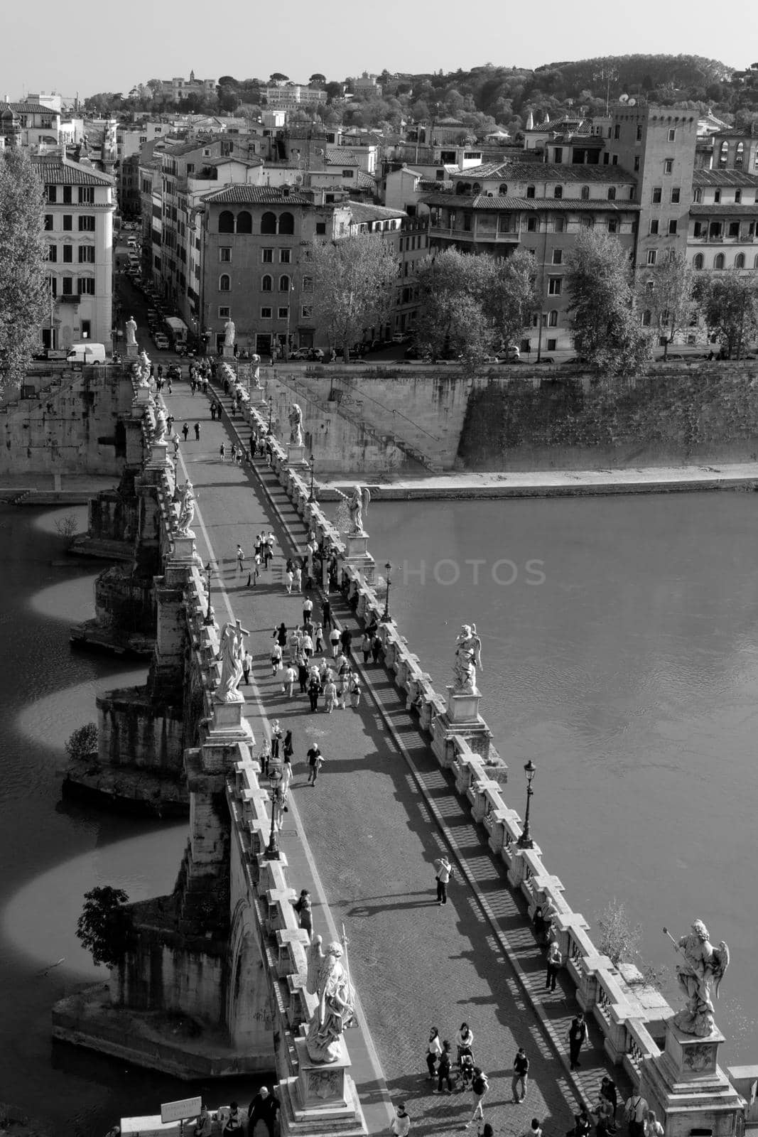 Bird's eye view of Sant'Angelo's bridge at Rome on a sunny day and a view of Rome's rooftops and river