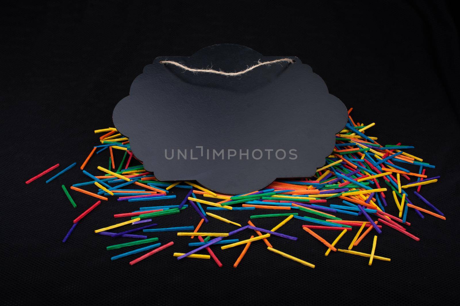 Black speech bubble shaped notice board  on colorful sticks on black