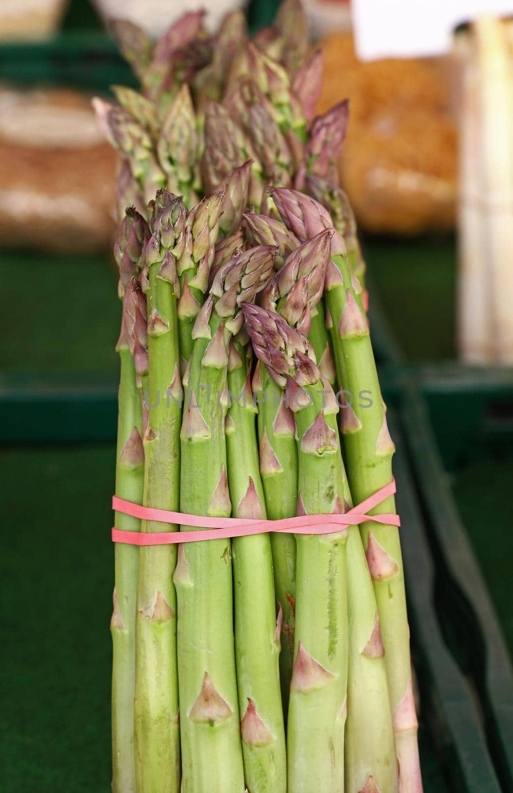 Bundle of fresh green asparagus close up by BreakingTheWalls