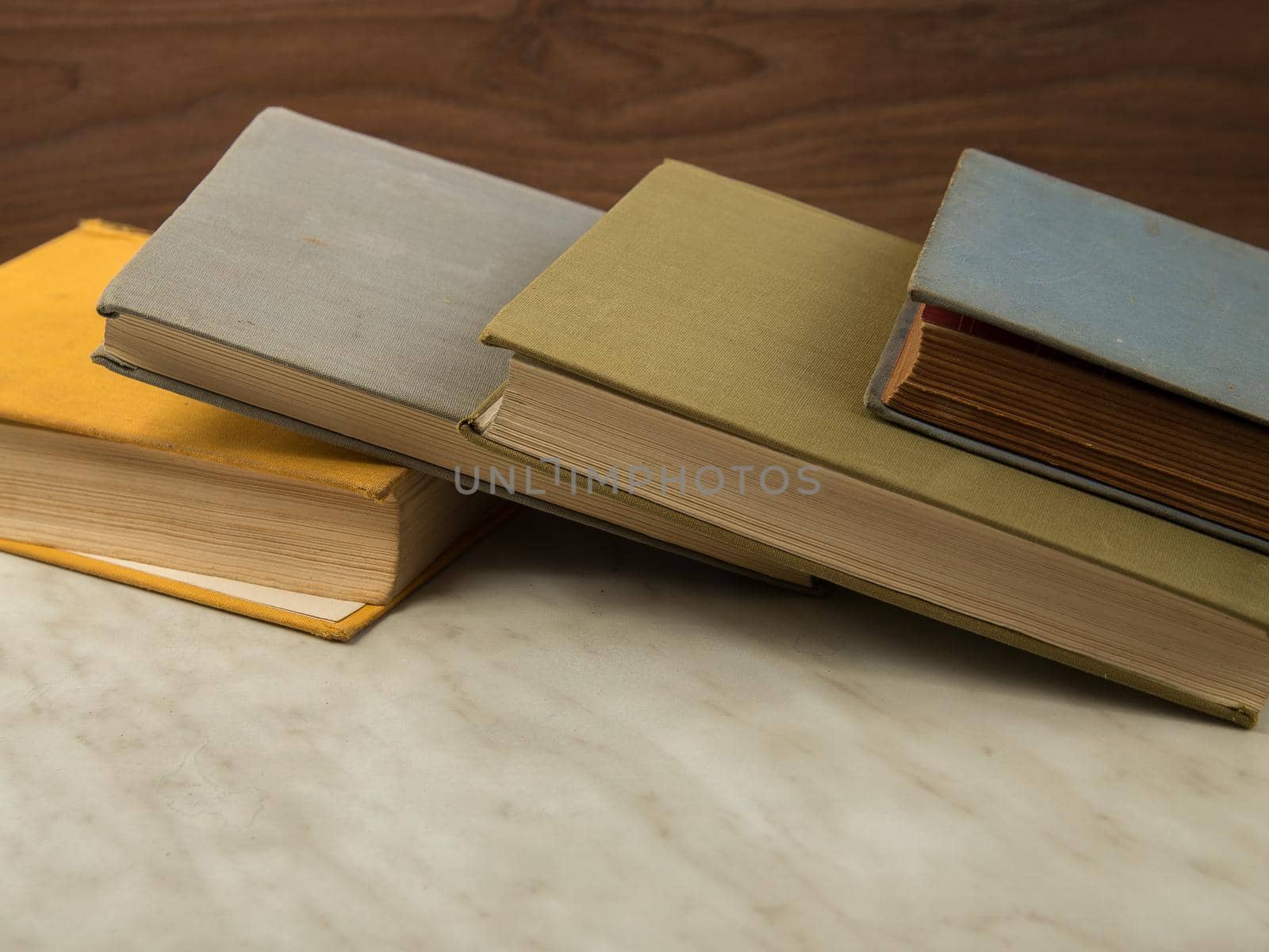 Old shabby books on light table.