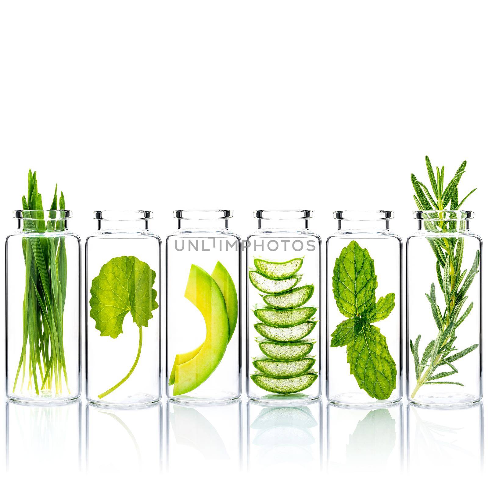 Homemade skin care with natural ingredients wheat grass ,avocado ,aloe vera ,mint leave ,centella asiatica and rosemary in glass bottles isolate on white background. by kerdkanno
