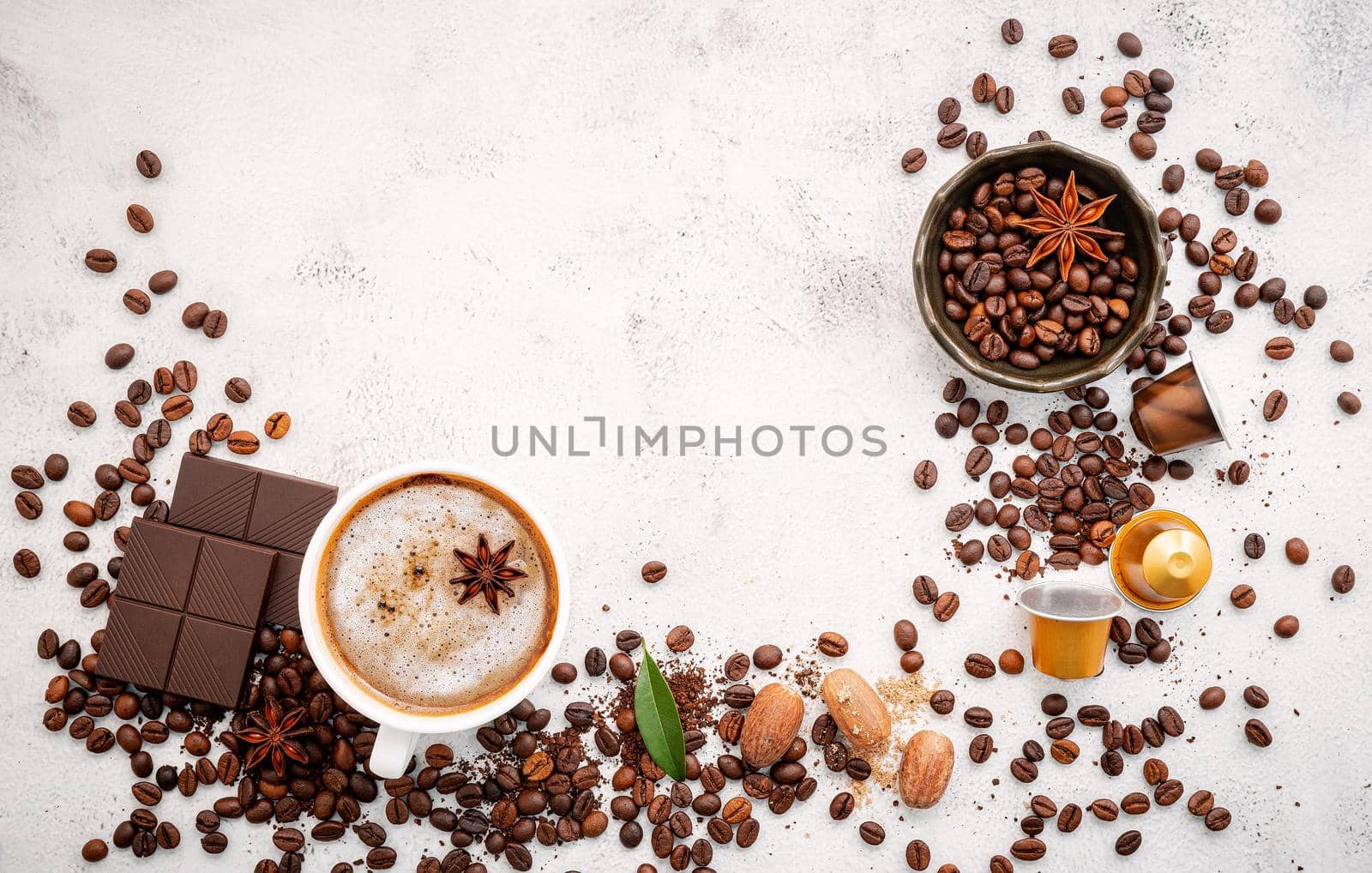 Background of various coffee , dark roasted coffee beans , ground and capsules with scoops setup on white concrete background with copy space.