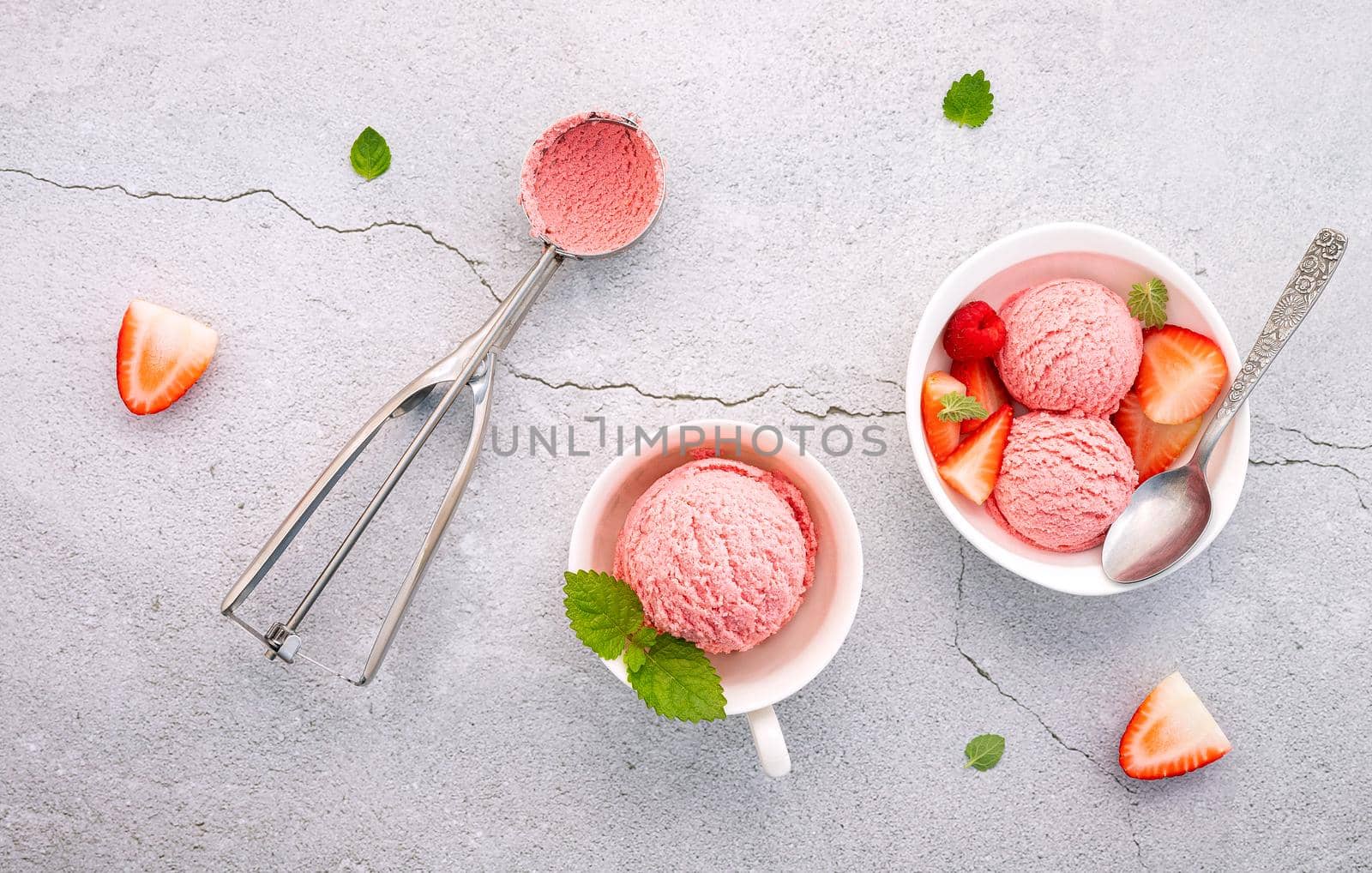 Strawberry  ice cream flavour in white  bowl setup on concrete background . Summer and Sweet menu concept.