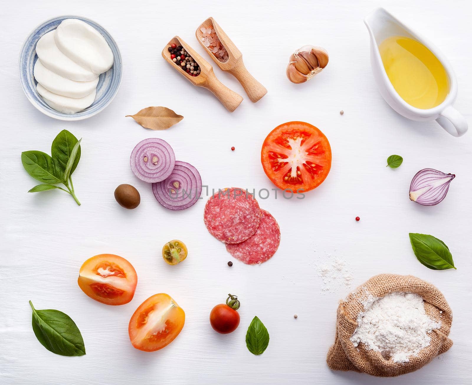 The ingredients for homemade pizza on white wooden background. by kerdkanno