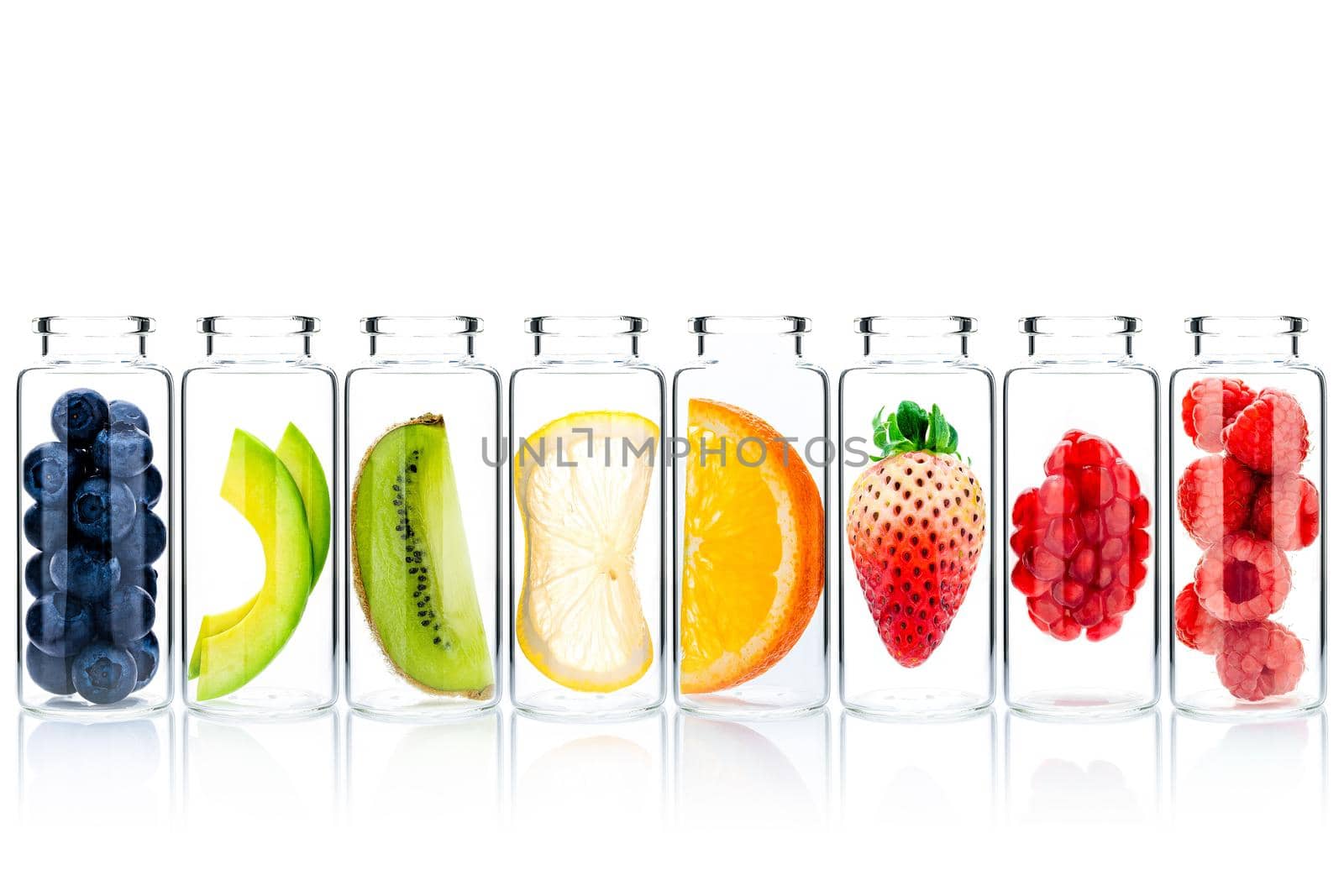 Homemade skin care with fruits ingredients avocado ,orange ,blueberry ,pomegranate ,strawberry and raspberry in glass bottles isolate on white background.