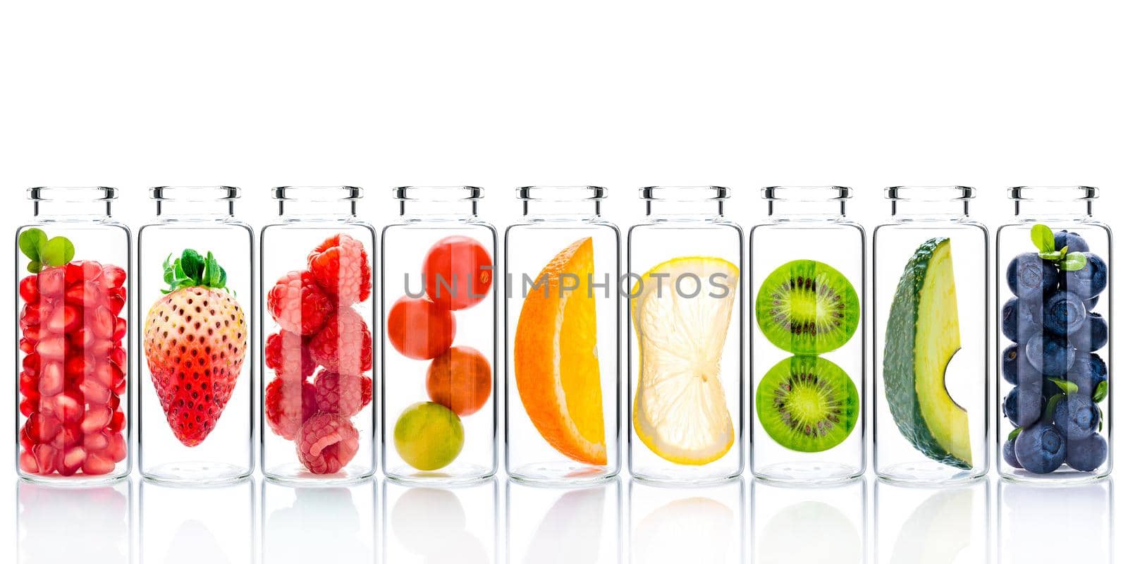 Homemade skin care with fruits ingredients avocado ,orange ,blueberry ,pomegranate ,strawberry and raspberry in glass bottles isolate on white background.