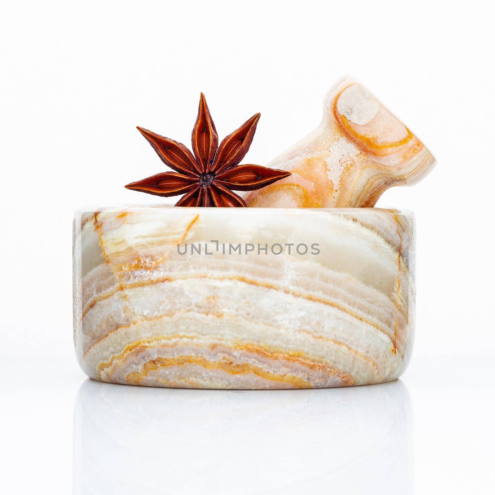 Closeup star anise in the marble mortar isolated on white background . Food conceptual ingredients and medical.  by kerdkanno