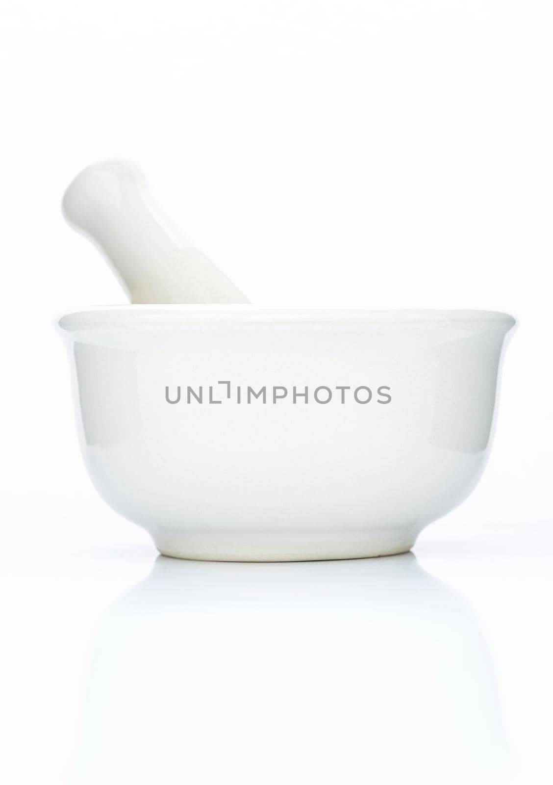 Closeup white ceramic mortar and pestle isolated on white background .  by kerdkanno