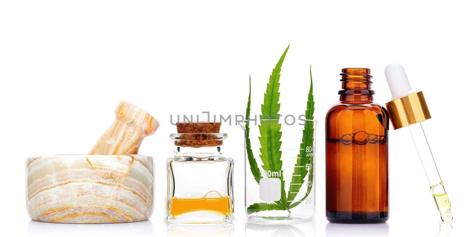 Glass bottles of cannabis oil and hemp leaves isolated on white background. Concept of using hemp in medicine. by kerdkanno