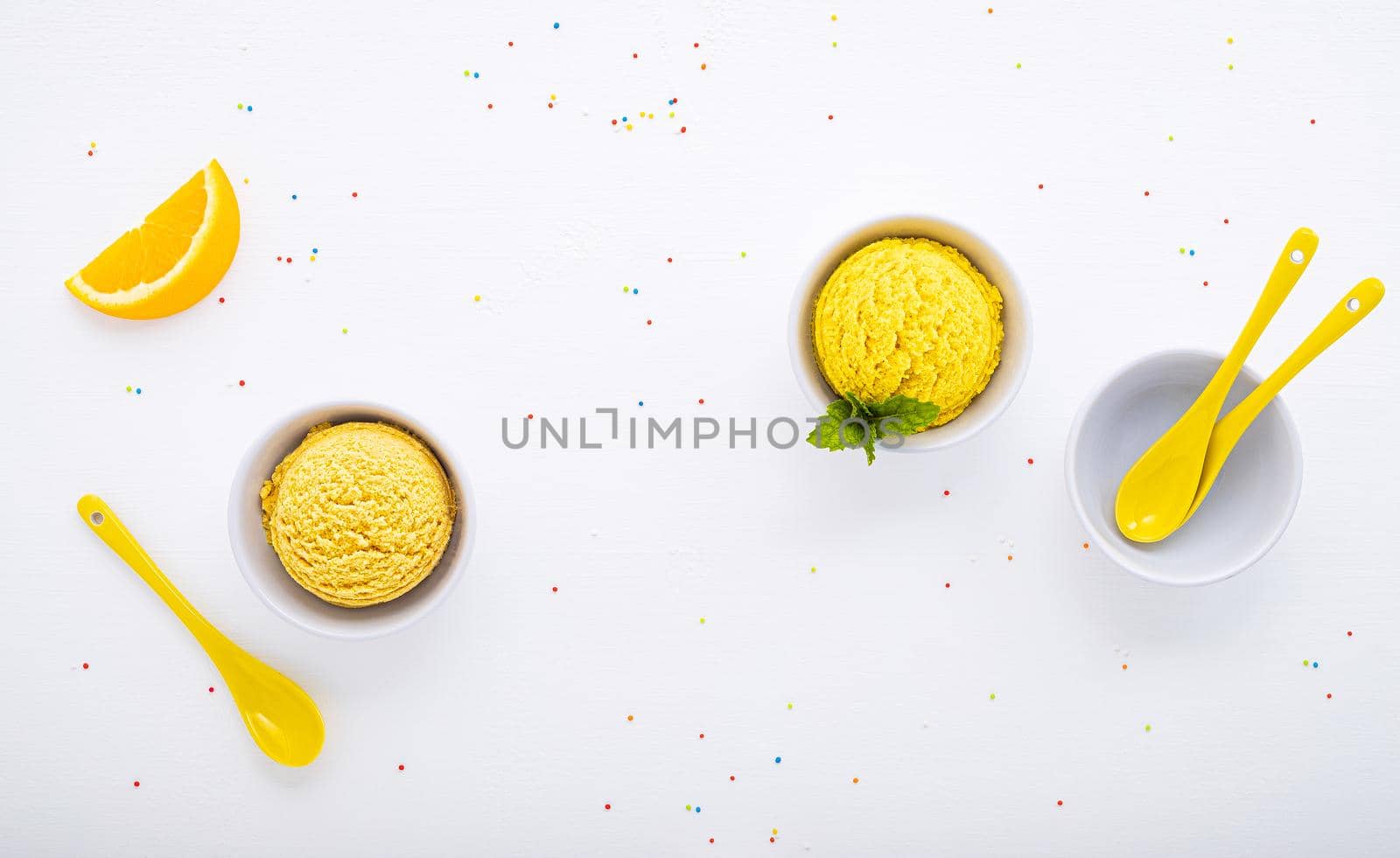 Various of ice cream flavor ball blueberry ,lime ,pistachio ,almond ,orange ,chocolate and vanilla set up on white wooden background . Summer and Sweet menu concept. by kerdkanno