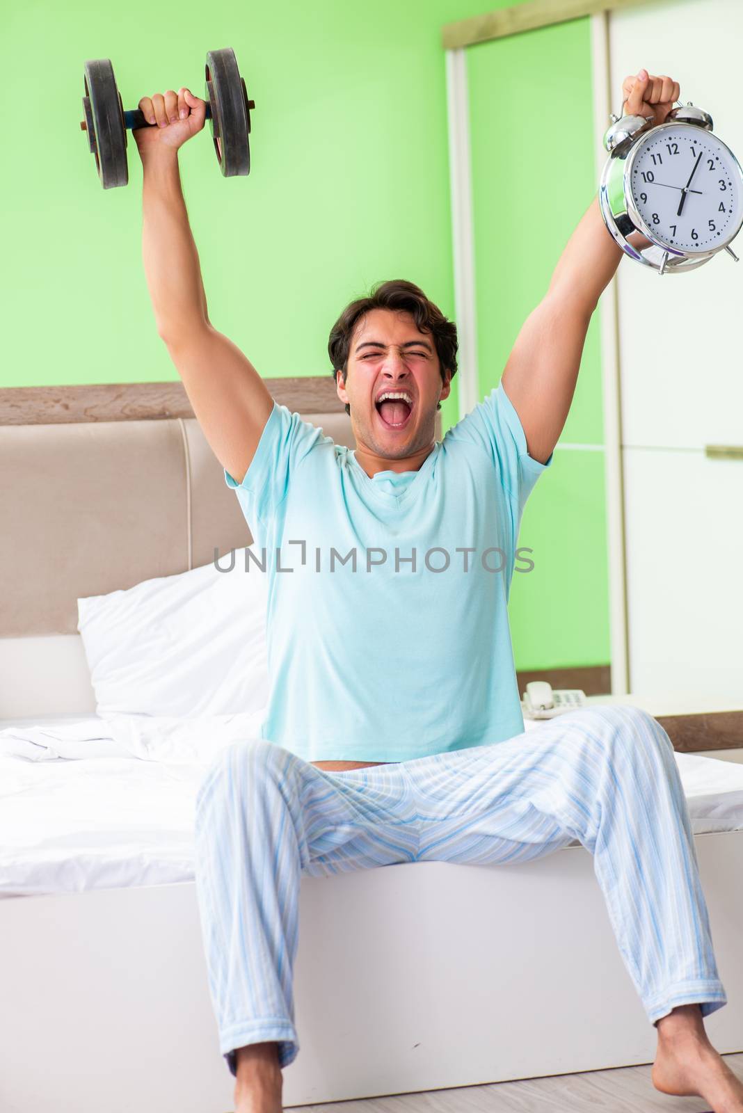 Young man in pajamas doing morning exercises 