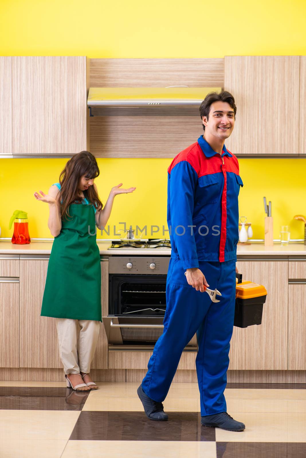 Woman with contractor at kitchen discussing repair