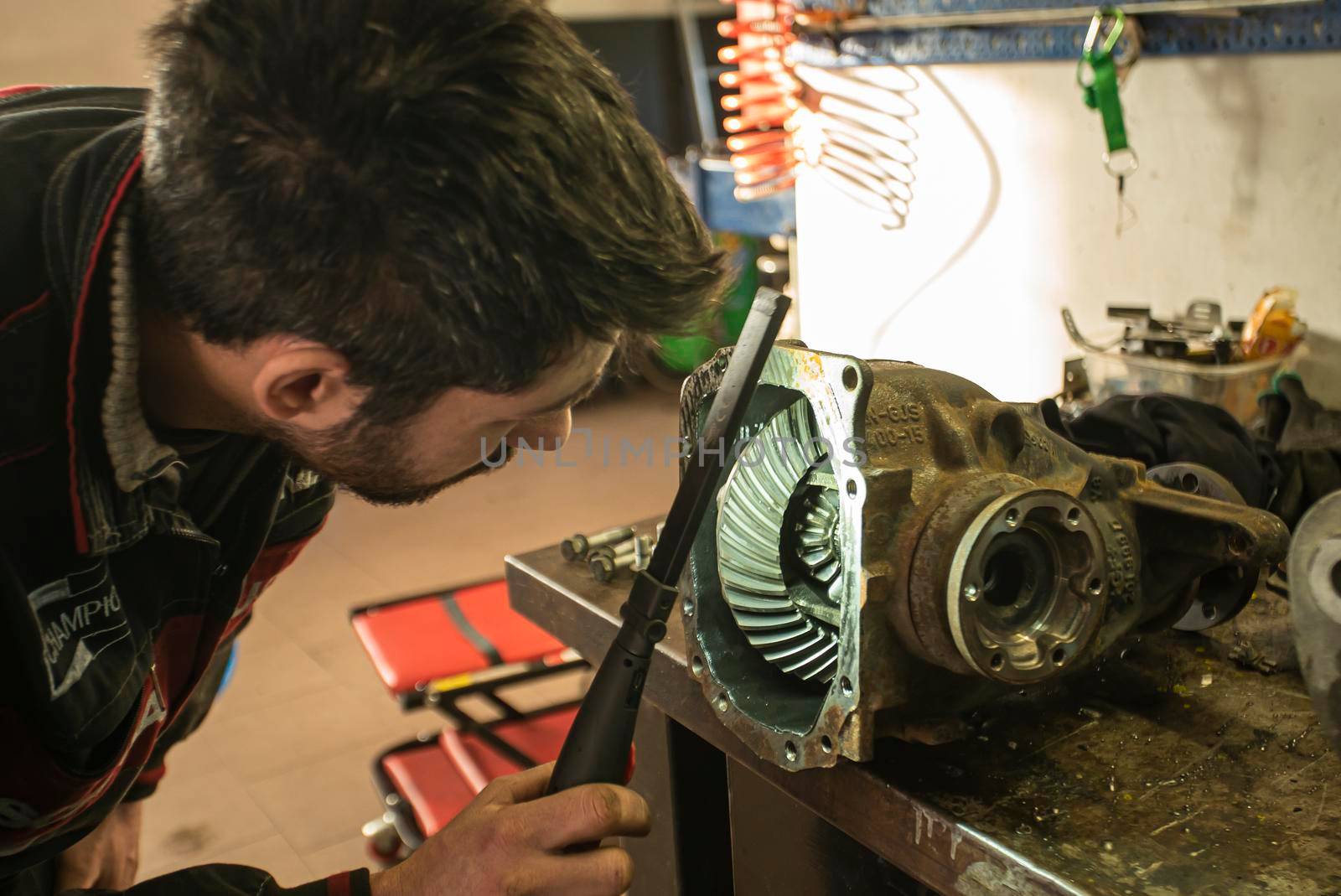 MILAN, ITALY 28 MARCH 2021: Mechanic repairs the gearbox