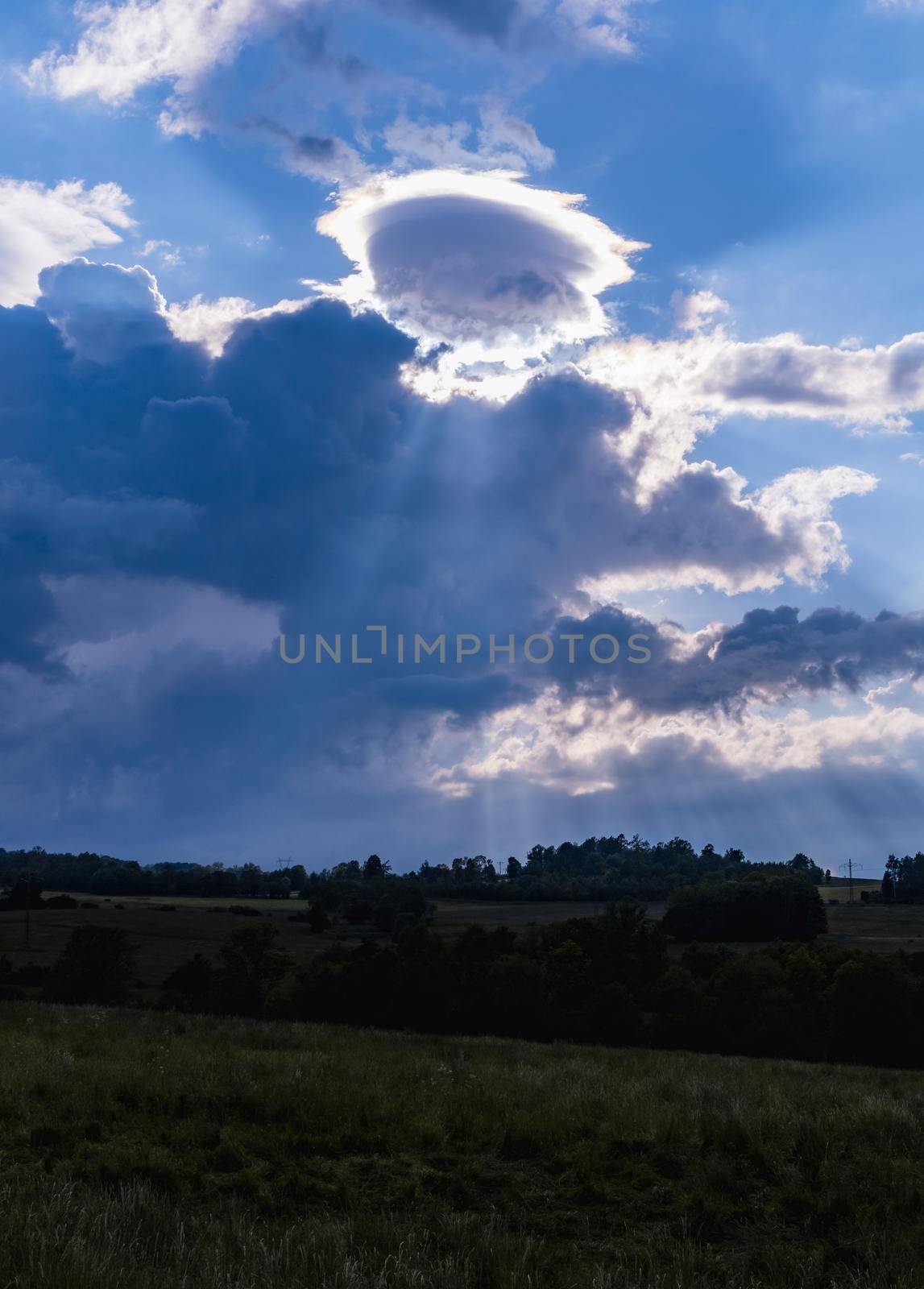 Beautiful cloudy sky with sun shining behind them by Wierzchu