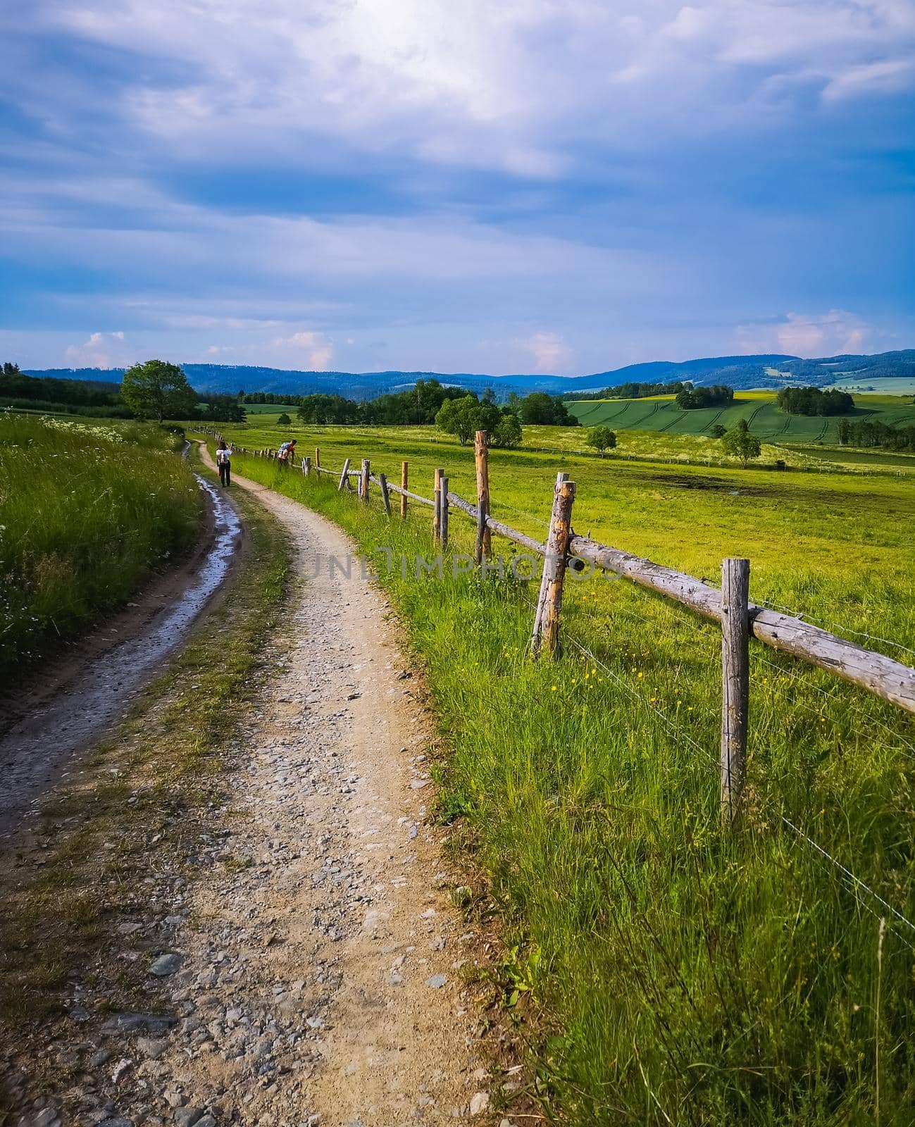 Long mountain trail with beautiful landscape in Rudawy Janowickie next to wooden railings  by Wierzchu