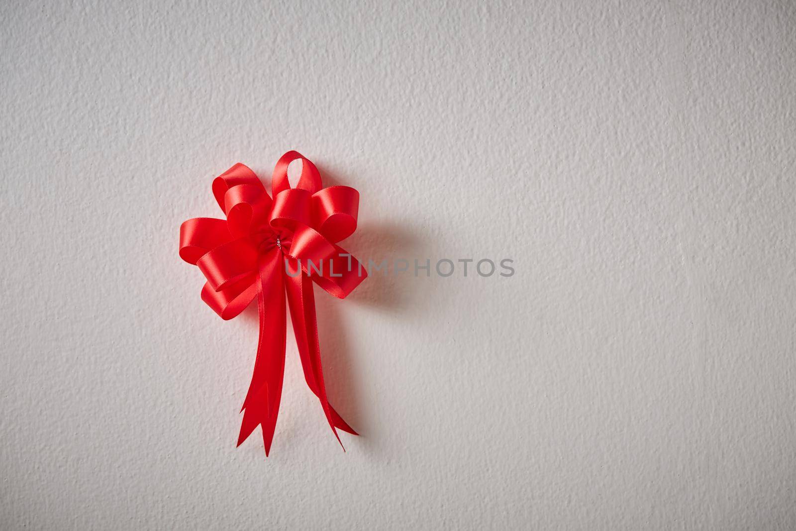 Red ribbon with copy space on texture wall