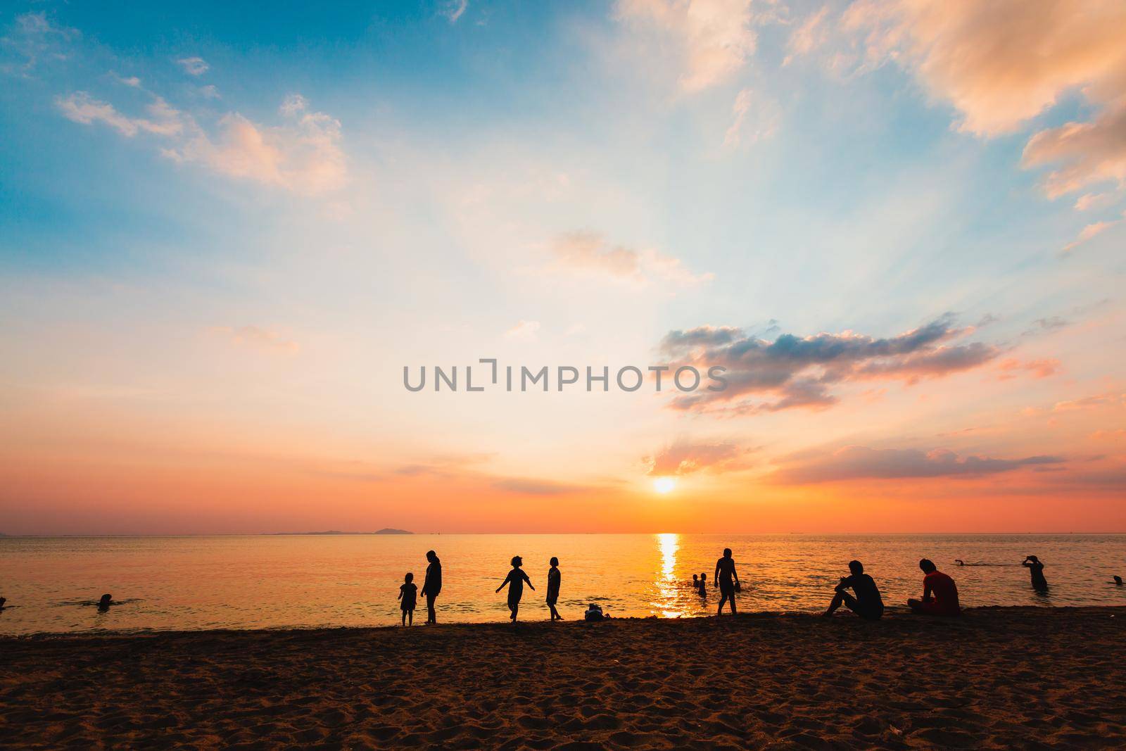 Silhouette people on the beach by Wasant