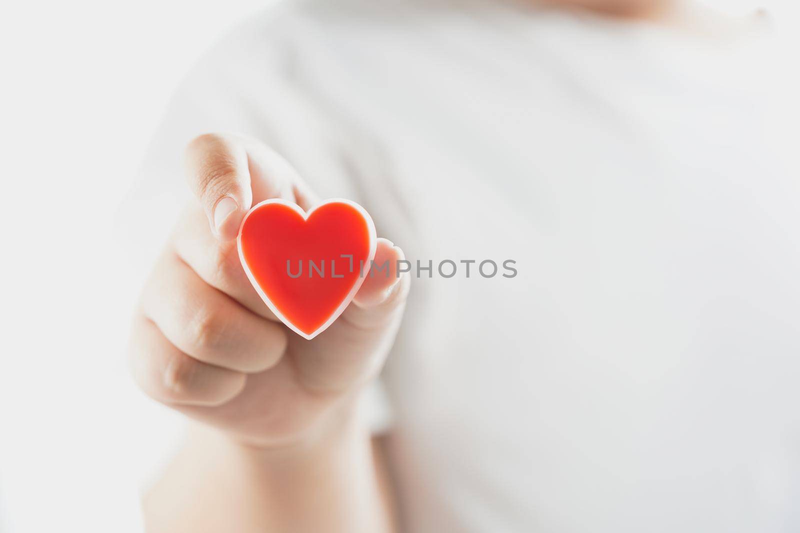 Hand holding a red heart of valentine's day concept