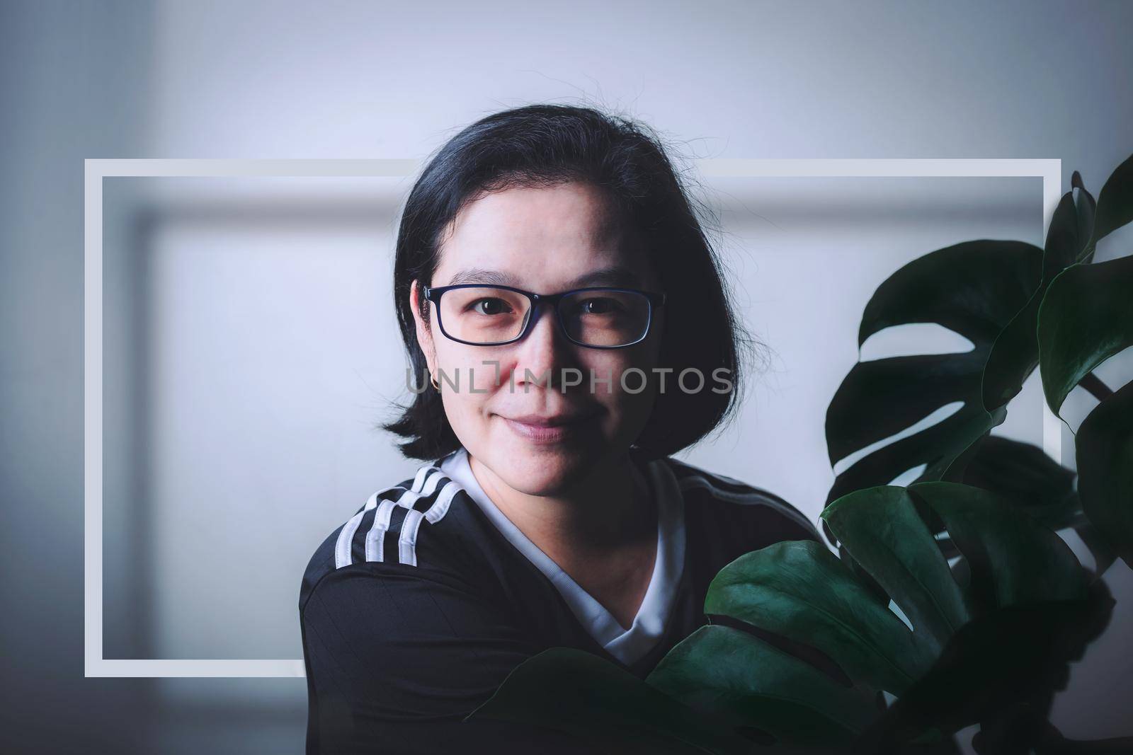 Portrait middle aged Asian woman is beautiful and Monstera leaf