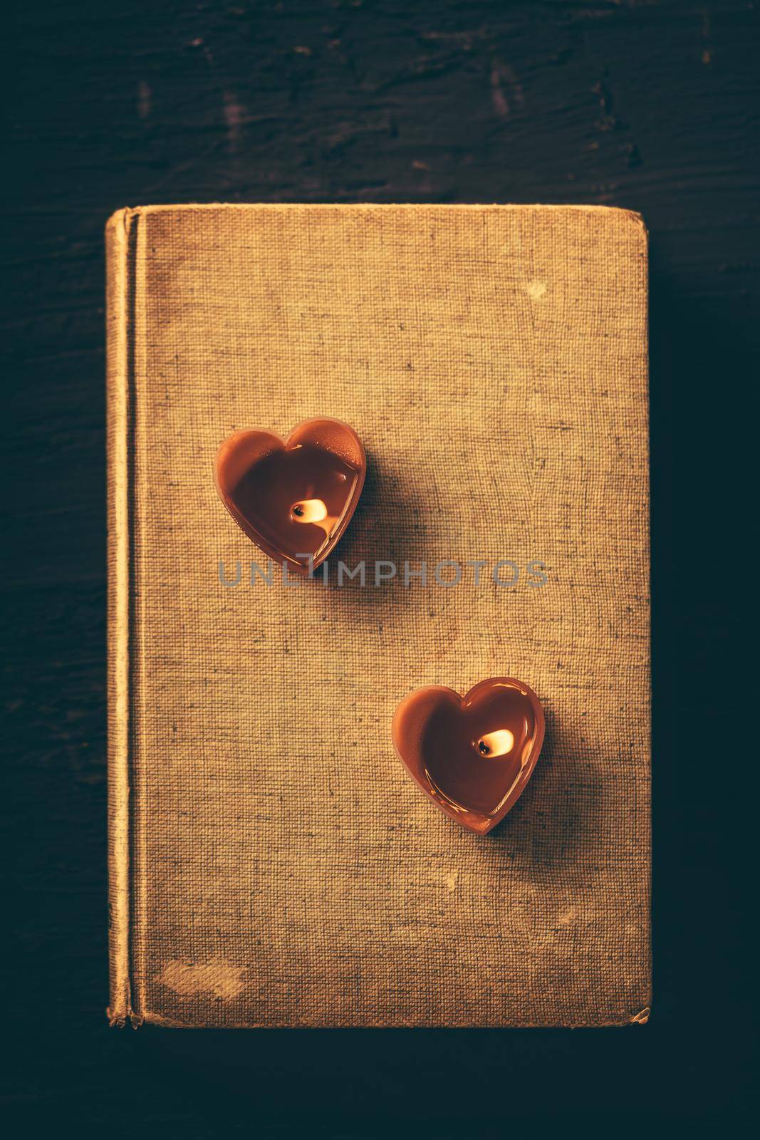 Couple heart is candles on old book, Vintage dark filter