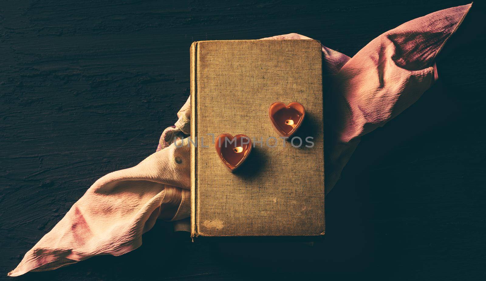 Couple heart is candles on old book, Vintage dark filter