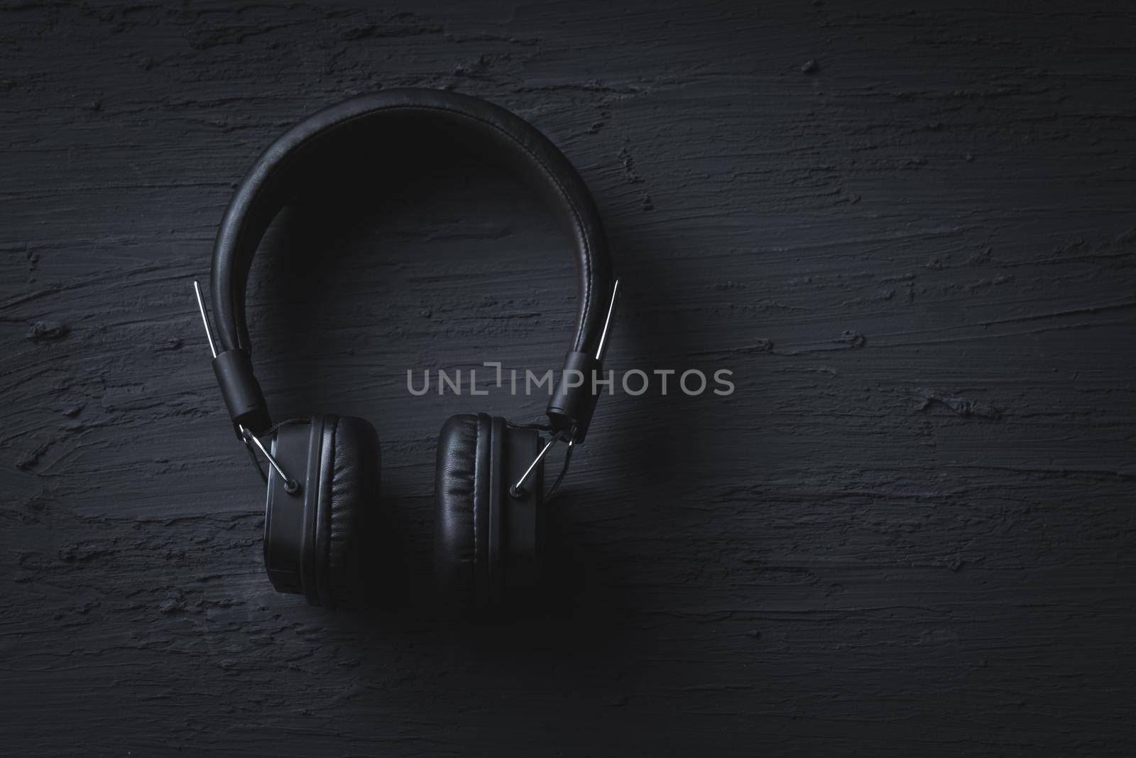 Music relax concept, Headphone on dark texture background