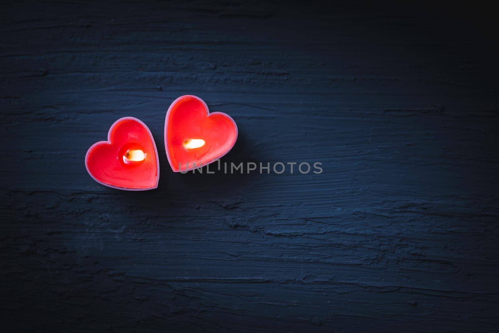 Couple heart is candles on dark background