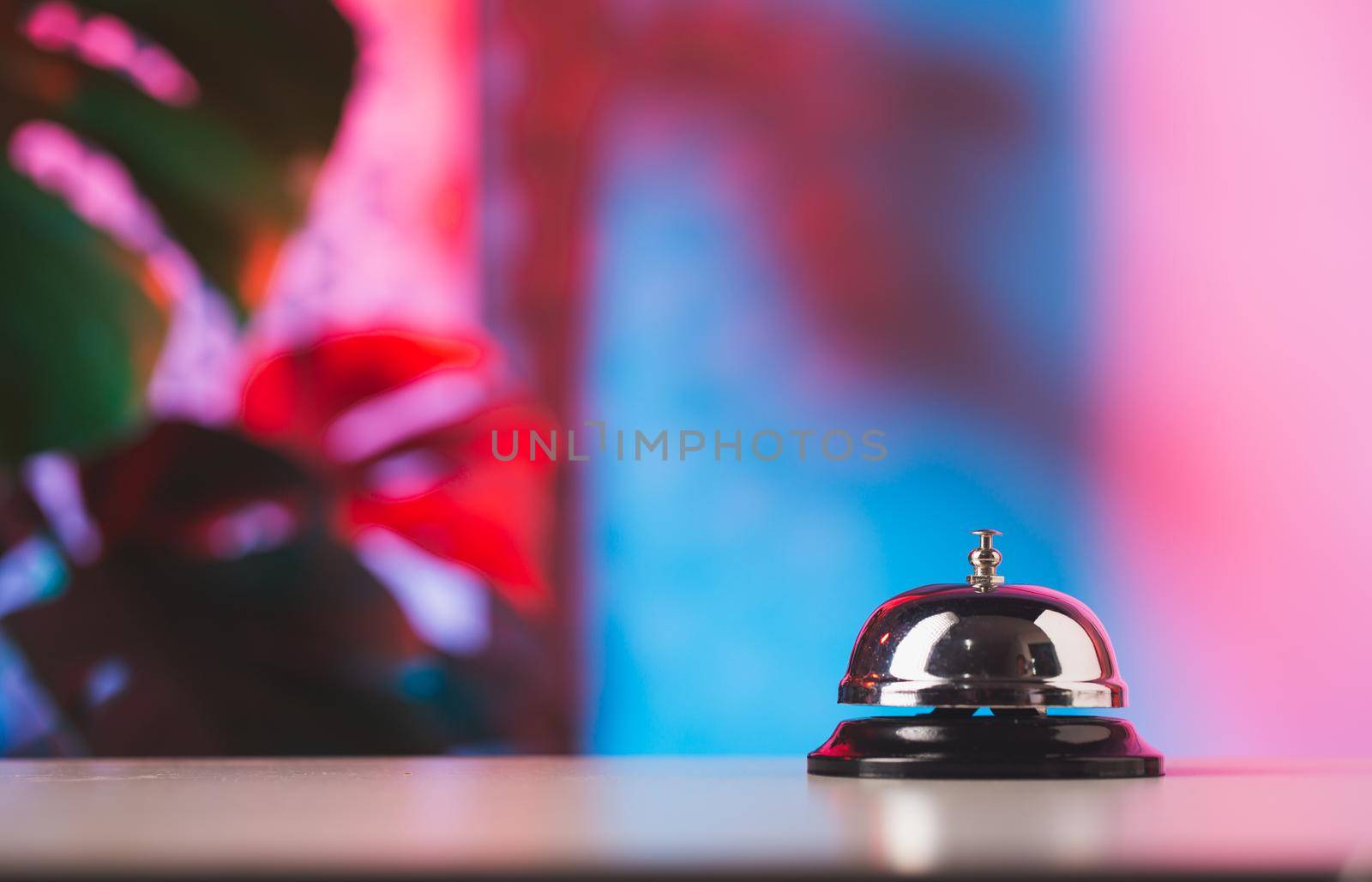 Bell of service on counter with colorful background