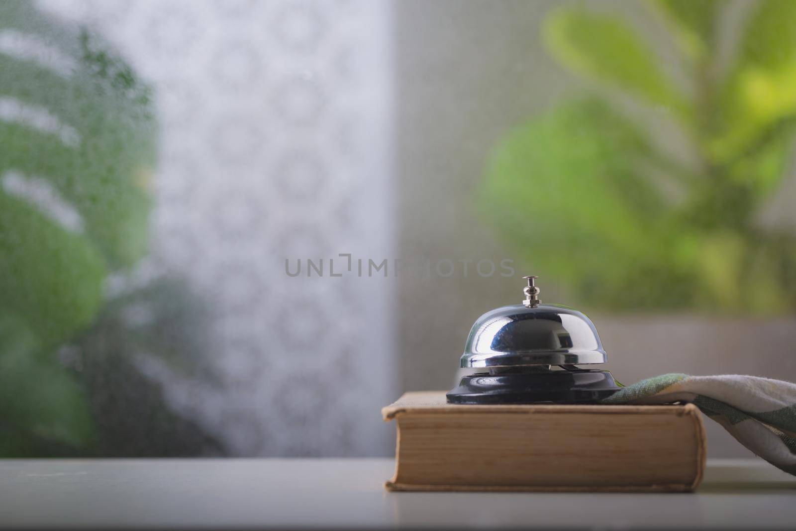 Bell of service on counter by Wasant