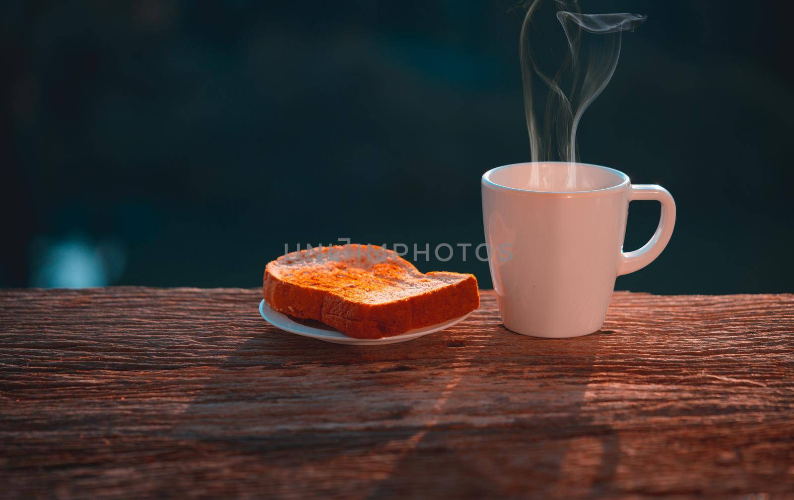 Coffee cup with bread on wooden table