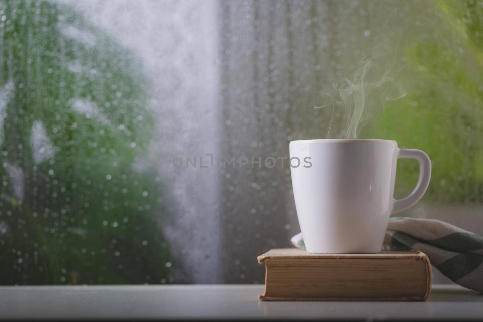 Coffee cup on a rainy day window background