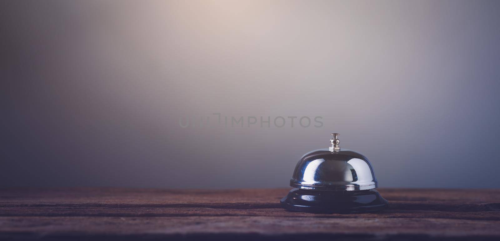 Bell of service on counter by Wasant