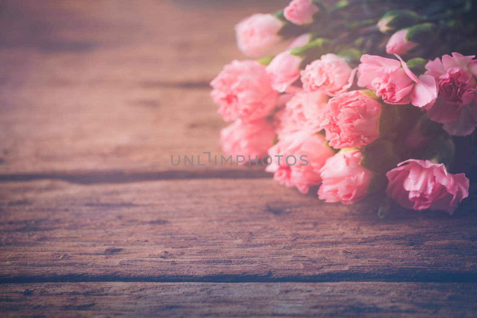 Still life with sweet carnation flowers on wooden table, Mothers day concept