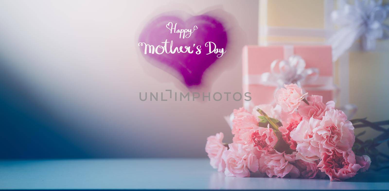 Still life with sweet carnation flowers, Message for Happy Mother's Day on a wooden heart