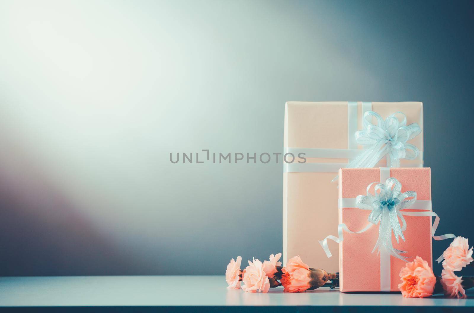 Still life with Gift Box and sweet Carnation flowers on table, Mothers day concept