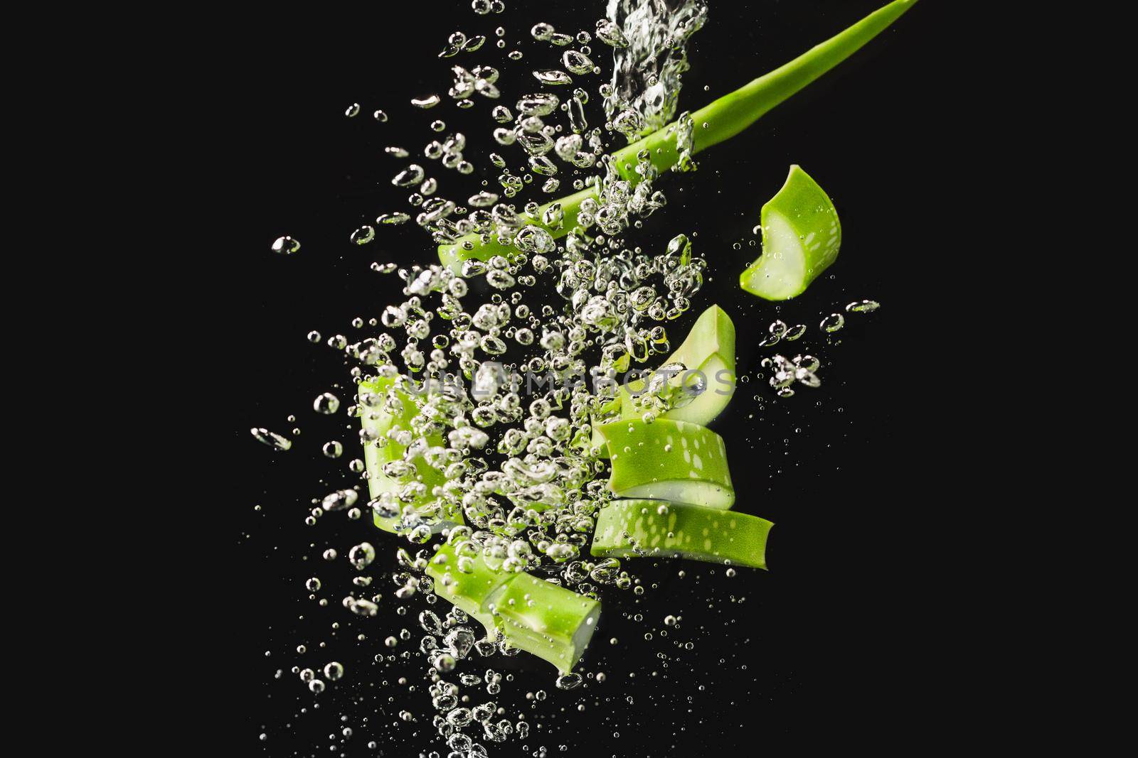 Aloe Vera sliced ,High speed freeze action shot of splashing into water with black background.