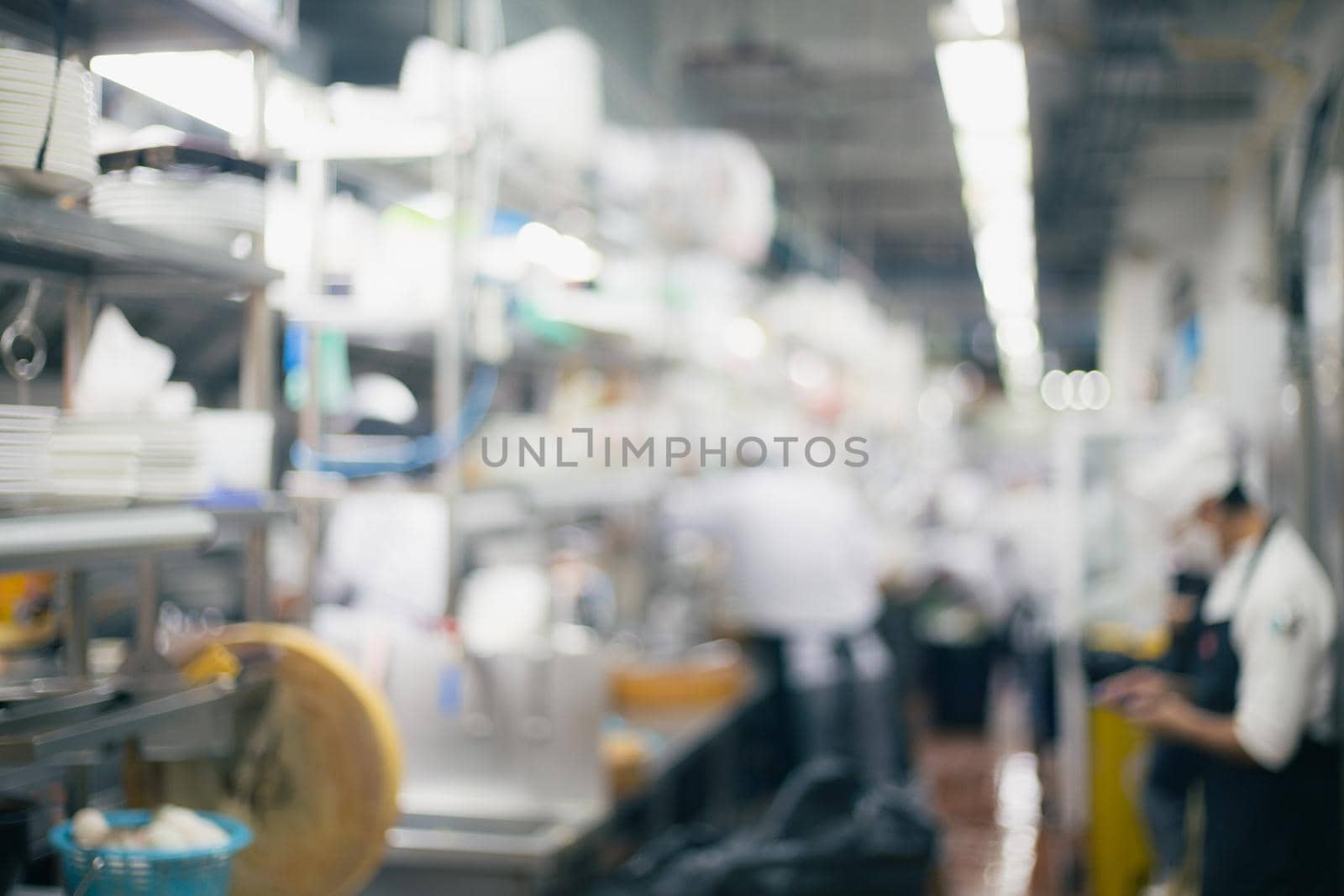 Blurred chefs of a restaurant kitchen background