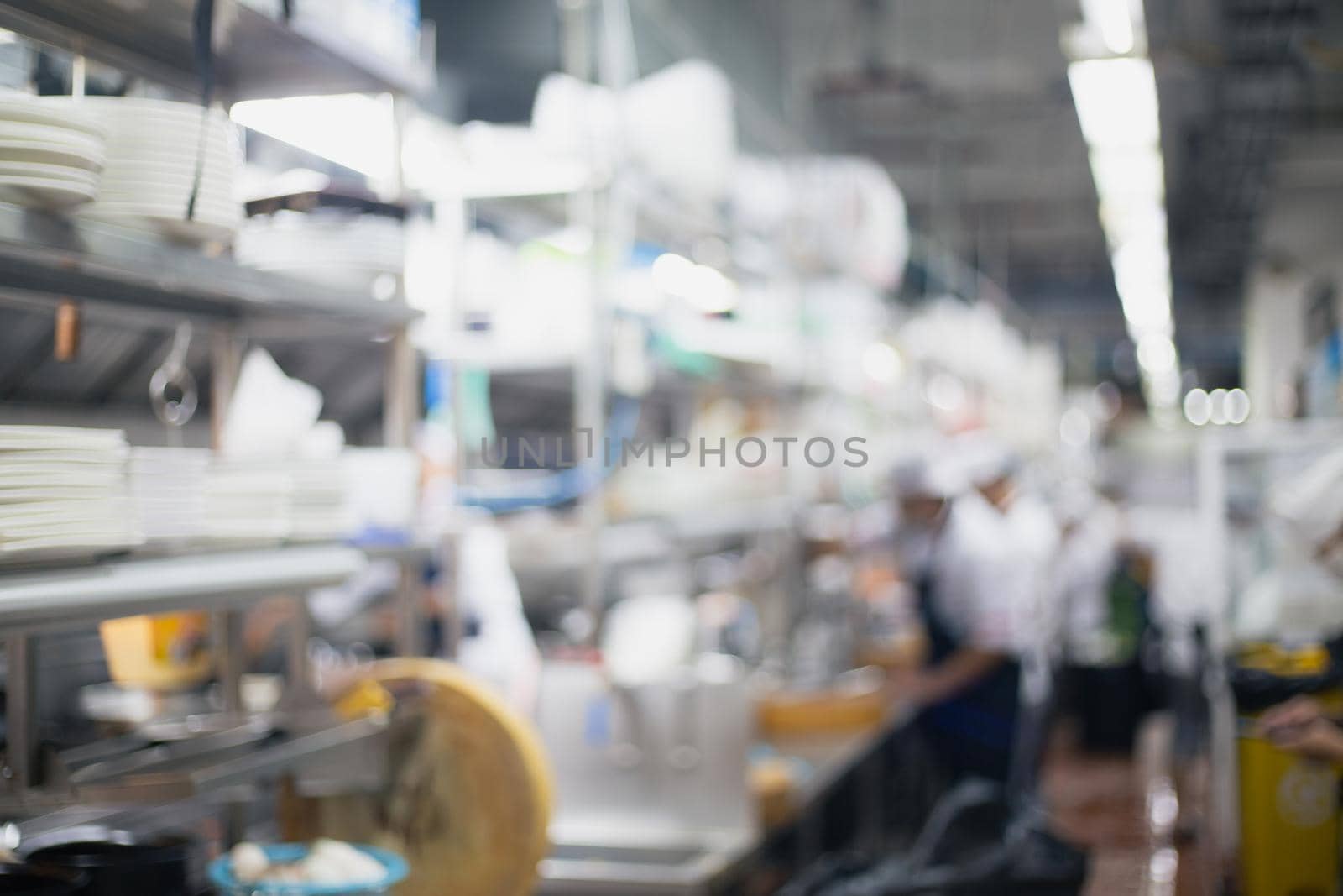 Blurred chefs of a restaurant kitchen background
