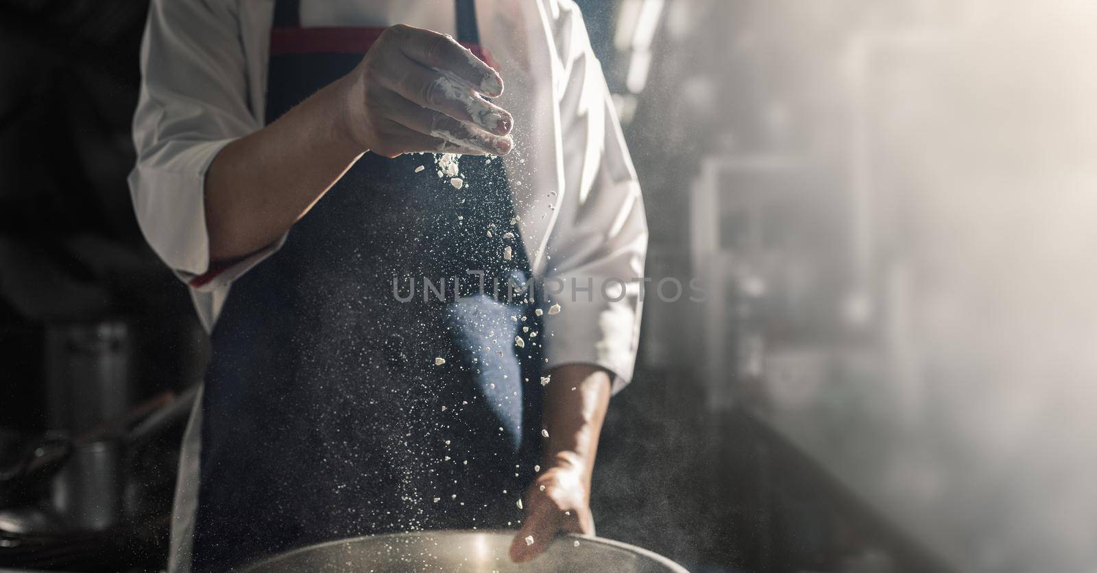 Chef sprinkles the flour by Wasant
