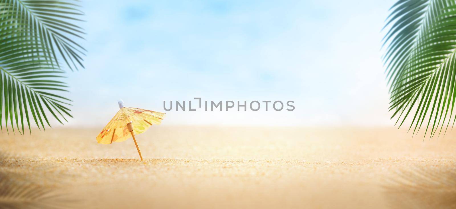 Beach mini umbrella with palm leaves, Summer on the beach concept