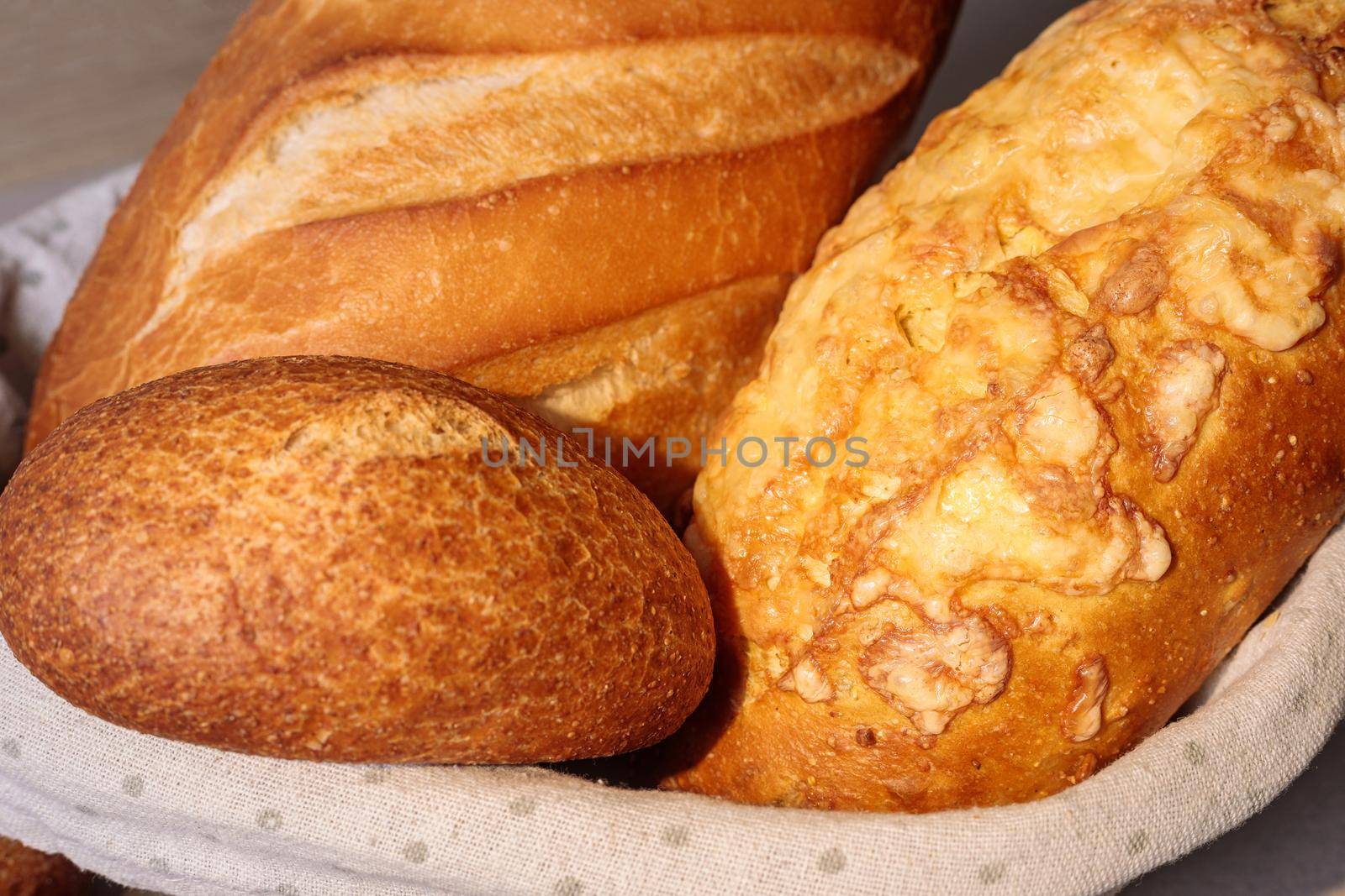 Fresh bread in a basket on a table with a fried crust. by Yurich32