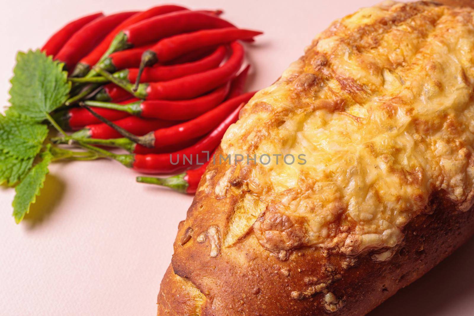 Slide of red chili peppers with green leaves and a loaf of bread. by Yurich32
