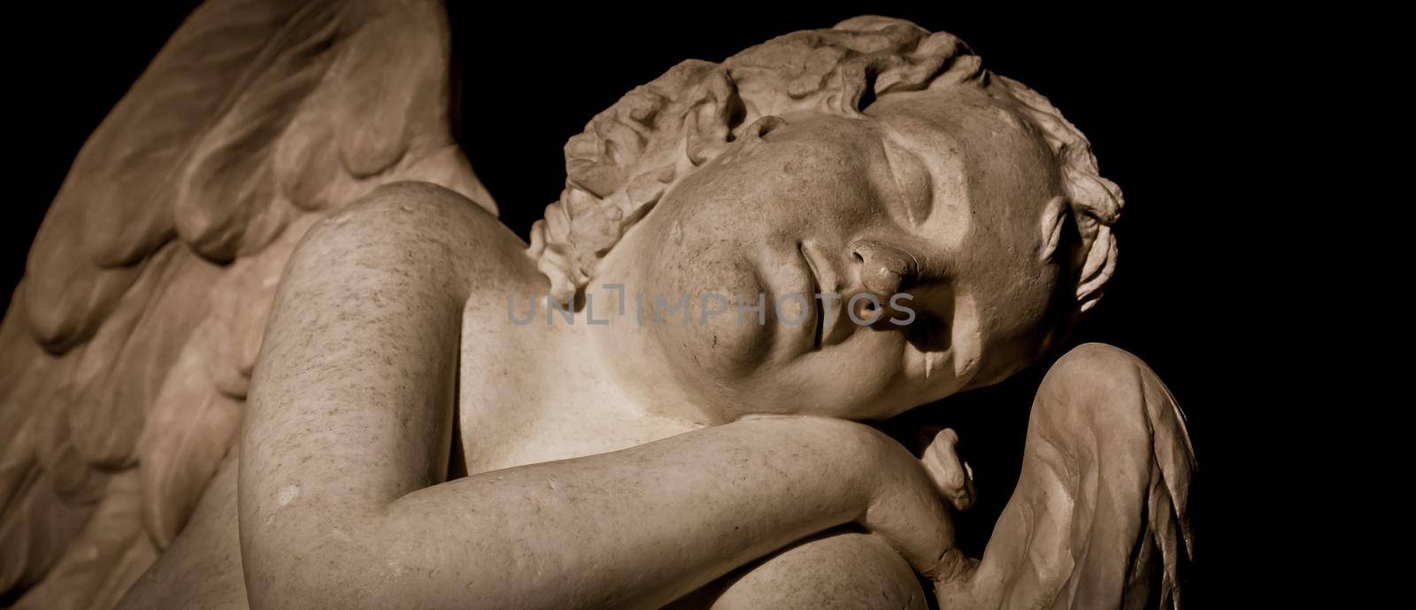 MILAN, ITALY - CIRCA AUGUST 2020: Cute sleeping angel. Statue made in marble, end of 18th century, unknown sculptor. Concept for sleep, innocence and newborrn.