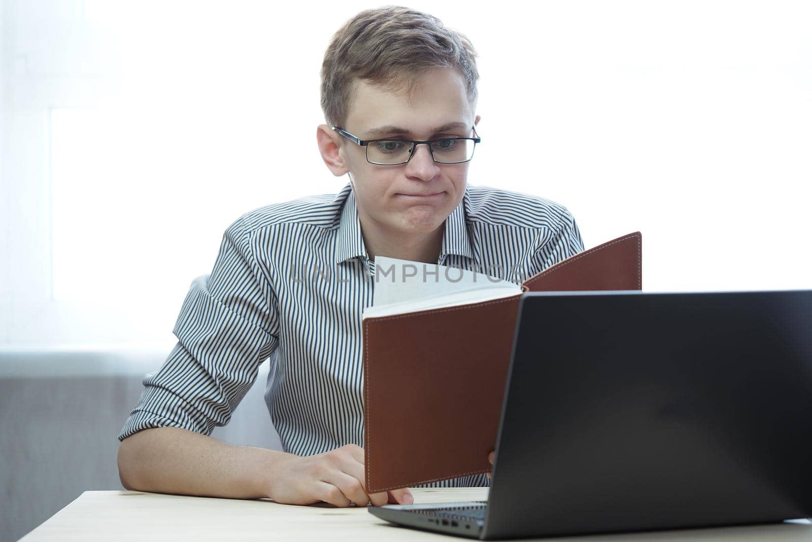 A young person has a remote job at the computer or training online. High quality photo