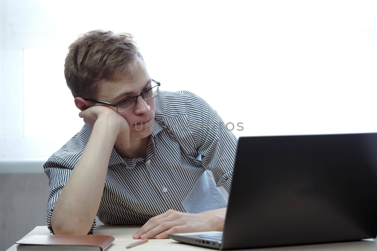 A young person has a remote job at the computer or training online. High quality photo