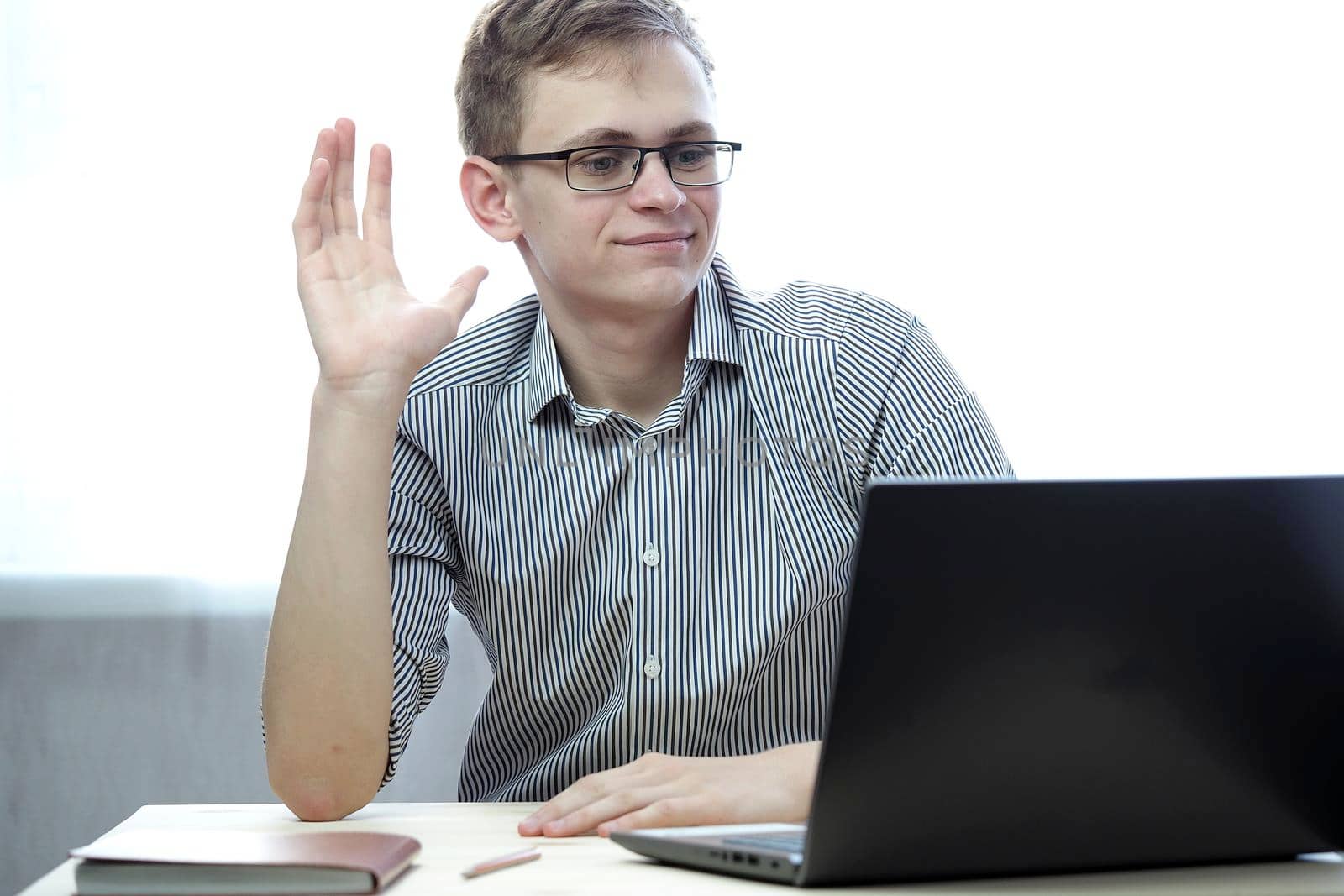 A young person has a remote job at the computer or training online. High quality photo