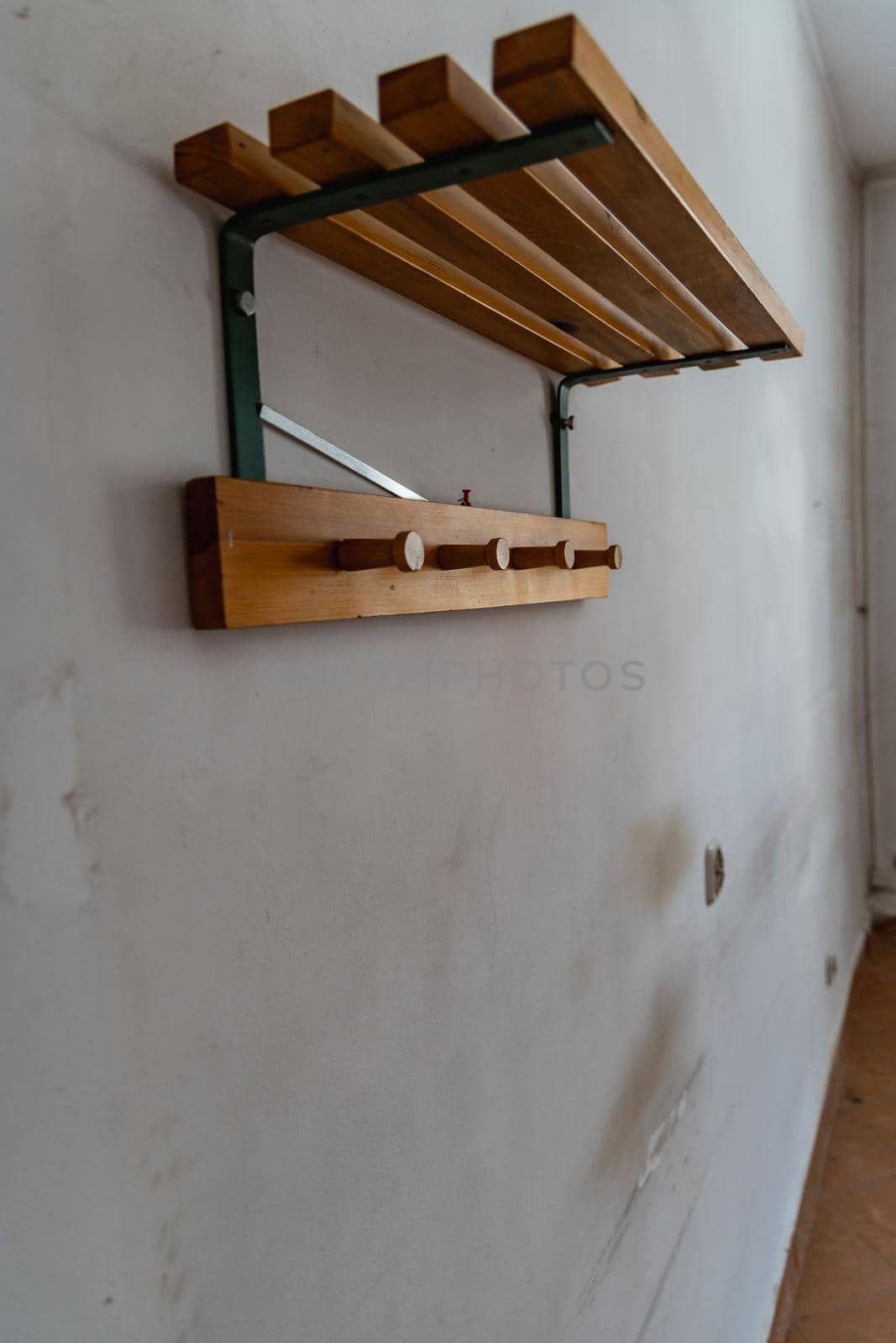 Old Wooden shelf with hangers at Urban exploration of buildings of old prison custody