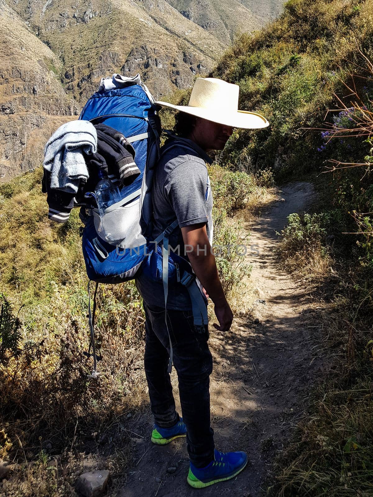 Man Traveler with hat and backpack hiking mountains Travel Lifestyle success concept adventure active summer vacations outdoor