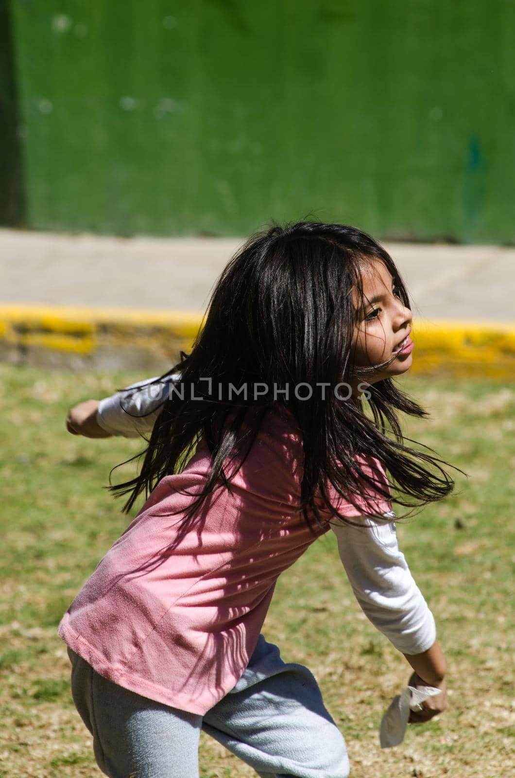 Little girl playing happily in the park running